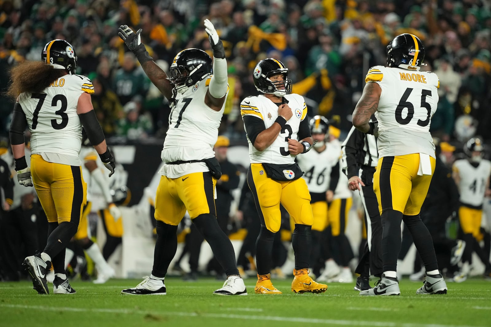 Pittsburgh Steelers quarterback Russell Wilson (3) reacts after a touchdown pass to teammate Pat Freiermuth during the first half of an NFL football game against the Philadelphia Eagles on Sunday, Dec. 15, 2024, in Philadelphia. (AP Photo/Matt Slocum)