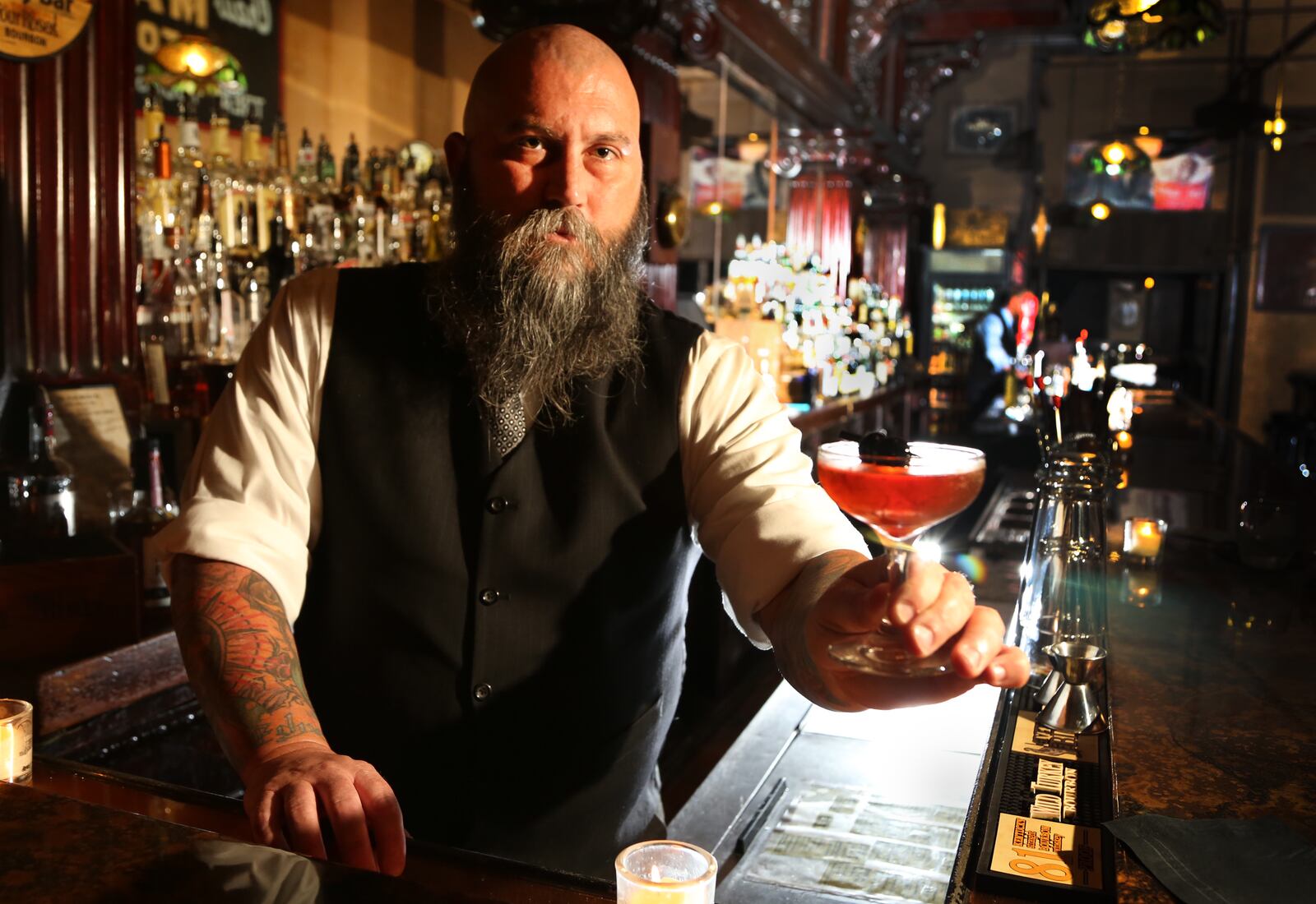 Co-owner Joseph Head with the Summer Cocktail " Remember the Maine" made with Rye Whiskey, Cherry Liquer, Bitters, Bulliet Rye and Sweet Vermouth at the Century Bar,  10 S Jefferson St, Dayton. JIM WITMER/STAFF