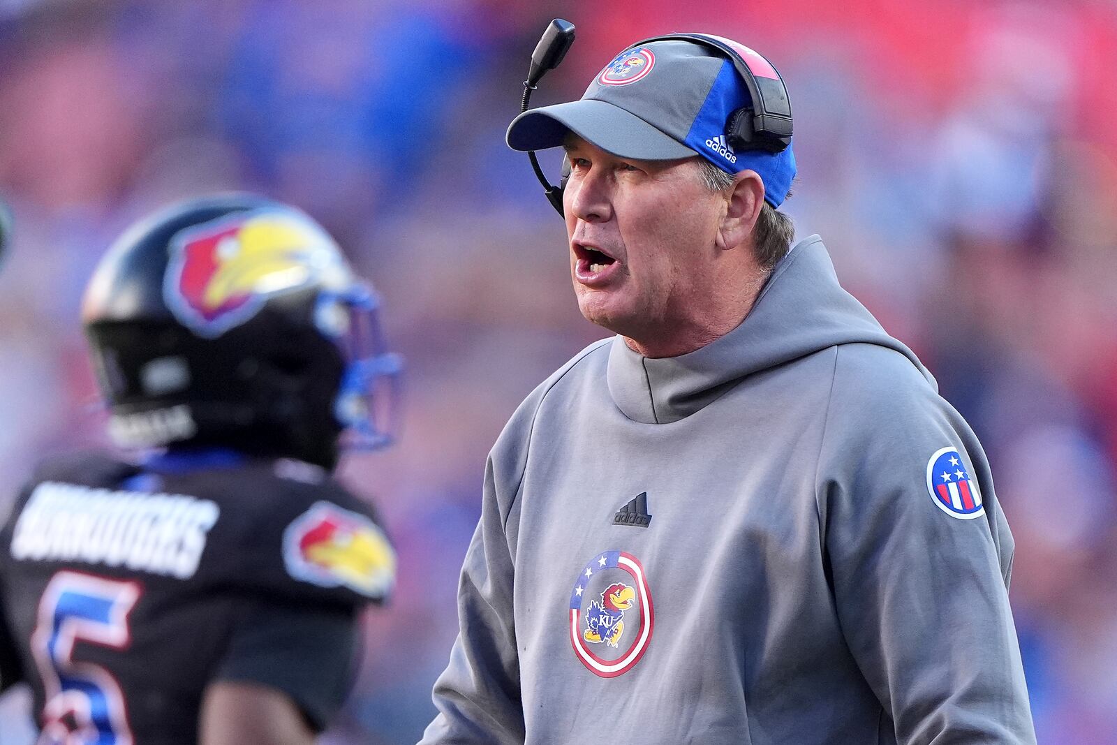 Kansas head coach Lance Leipold talks to his players during the first half of an NCAA college football game against Iowa State Saturday, Nov. 9, 2024, in Kansas City, Mo. (AP Photo/Charlie Riedel)