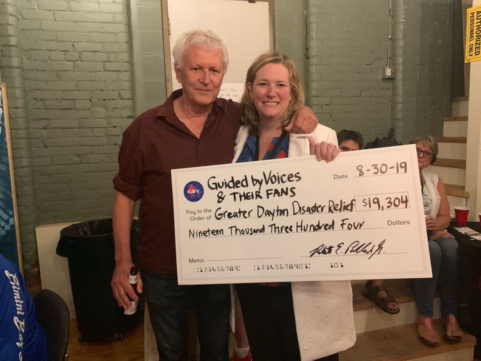 Guided By Voices leader Robert Pollard presenting a check for disaster relief to former Dayton Mayor Nan Whaley in 2019.