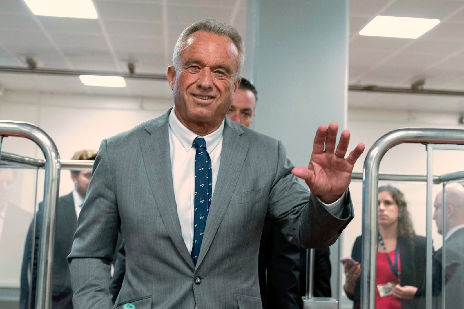 Robert F. Kennedy Jr., President-elect Donald Trump's nominee to be Secretary of Health and Human Services, waves to the media as he rides the train to go to meet with Sen. John Thune, R-S.D. at the Capitol in Washington, Tuesday, Dec. 17, 2024. (AP Photo/Jose Luis Magana)