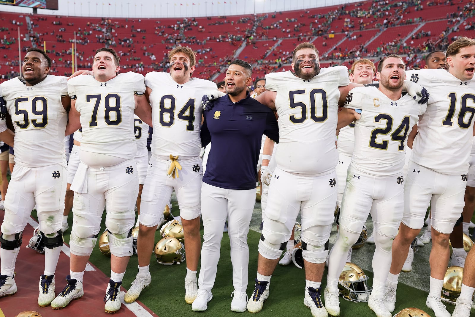 Notre Dame head coach Marcus Freeman, center, chants with his players after the team's win against Southern California in an NCAA football game Saturday, Nov. 30, 2024, in Los Angeles. (AP Photo/Ryan Sun)