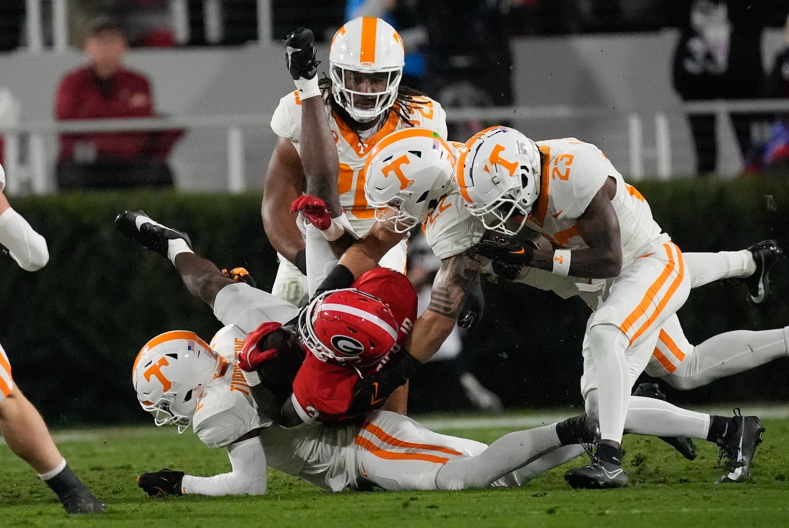 Georgia running back Nate Frazier (3) is stopped by Tennessee defensive back Andre Turrentine (2), defensive back Boo Carter (23) and linebacker Jeremiah Telander (22) during the first half of an NCAA college football game, Saturday, Nov. 16, 2024, in Athens, Ga. (AP Photo/John Bazemore)