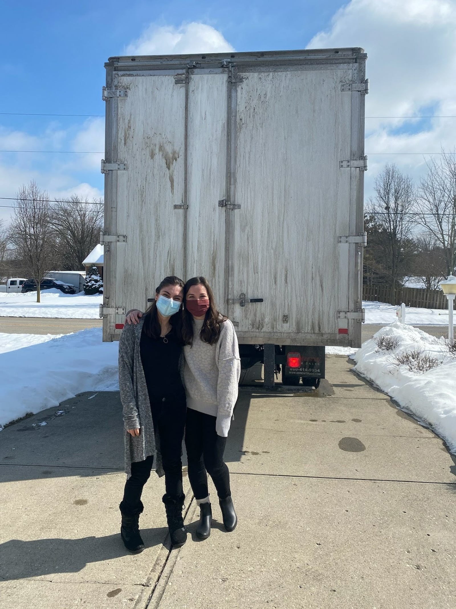 Monica Nedeff, left, and her best friend Emma Schuermann, from their days at Alter high School, stand in front of the moving truck before departing Dayton to move to North Carolina in 2021. CONTRIBUTED