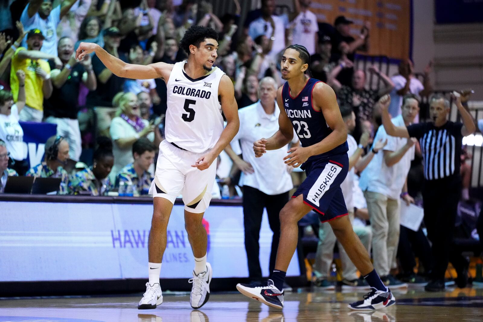 Colorado guard RJ Smith (5) reacts after a basket as UConn forward Jayden Ross (23) looks on during the second half of an NCAA college basketball game at the Maui Invitational Tuesday, Nov. 26, 2024, in Lahaina, Hawaii. Colorado won 73-72. (AP Photo/Lindsey Wasson)