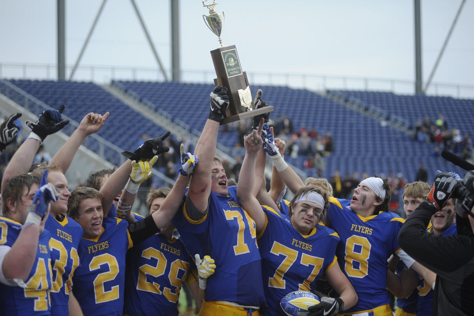 John Dirksen (74) and the Flyers celebrate. Marion Local defeated Kirtland 34-11 to win a D-VI high school football state title at Canton on Sat., Dec. 2, 2017. MARC PENDLETON / STAFF