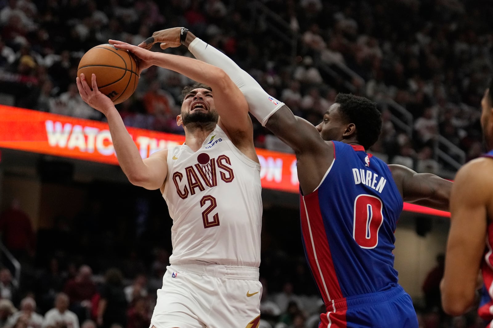 Cleveland Cavaliers guard Ty Jerome (2) goes up to shoot while defended by Detroit Pistons center Jalen Duren (0) in the first half of an NBA basketball game, Friday, Oct. 25, 2024, in Cleveland. (AP Photo/Sue Ogrocki)