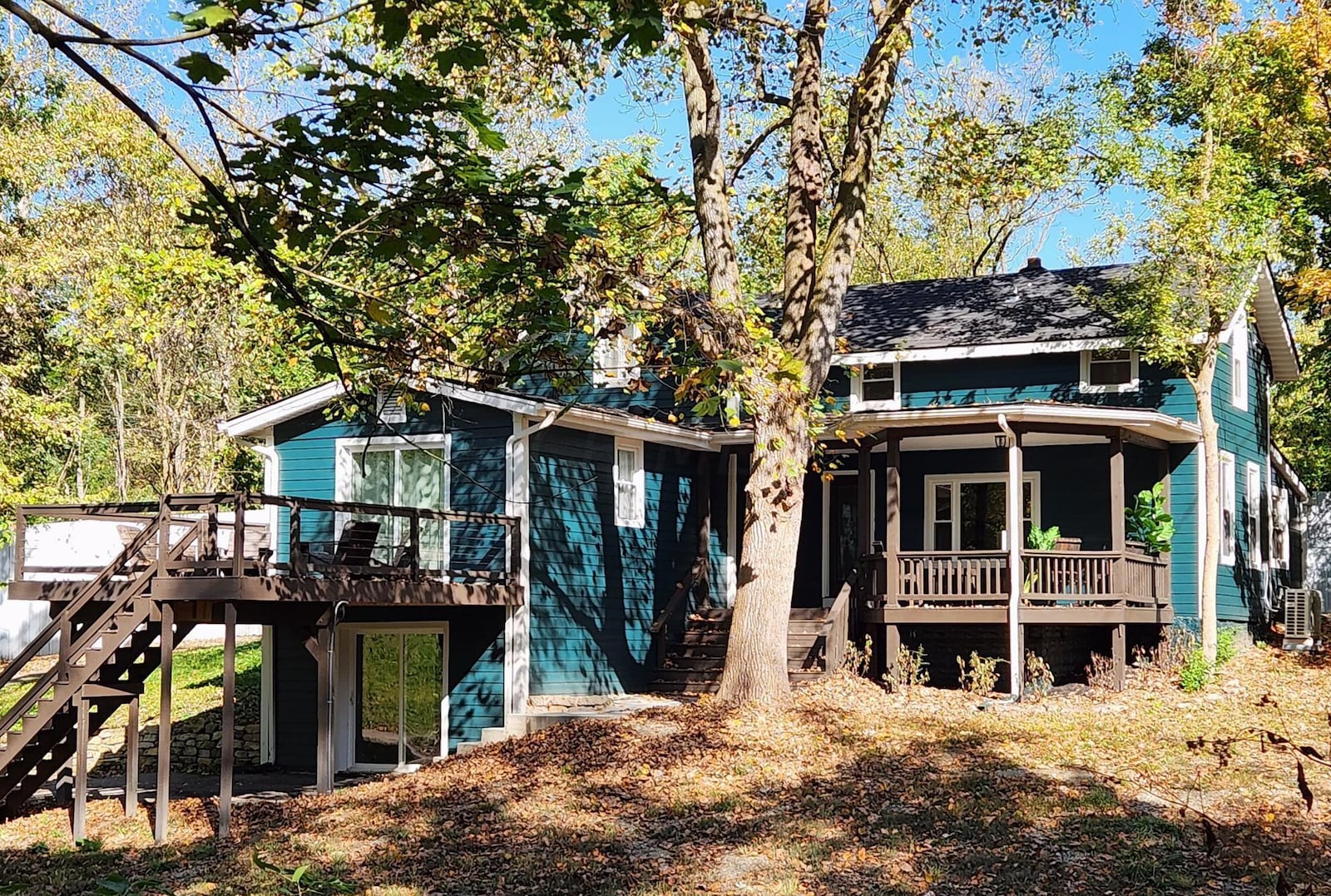 The side of the home has a private deck off the primary bedroom and a patio beneath, which is connected to the basement bedroom.