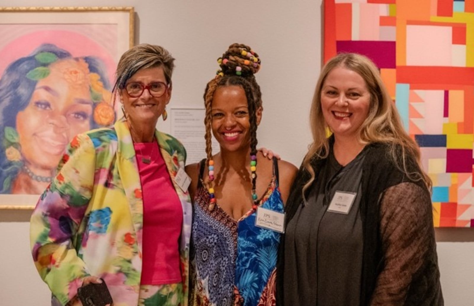 Art collector Sara M. Vance Waddell, Artist Erin Smith Glenn, and Artist Heather Jones stand near Glenn's artwork, at the left, titled "Breonna Taylor" and Jones' work "There's No Plan," seen at the right. CONTRIBUTED