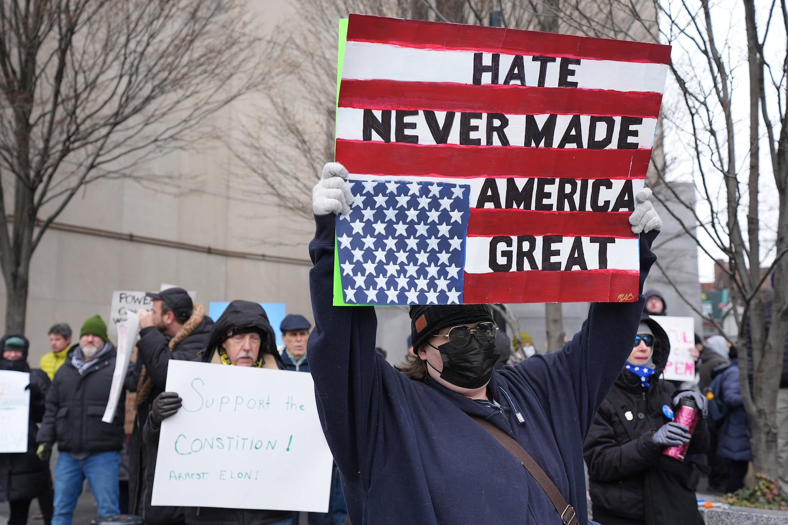 People protest outside the federal courthouse in Pittsburgh on Wednesday, Feb. 5, 2025. (AP Photo/Gene J. Puskar)