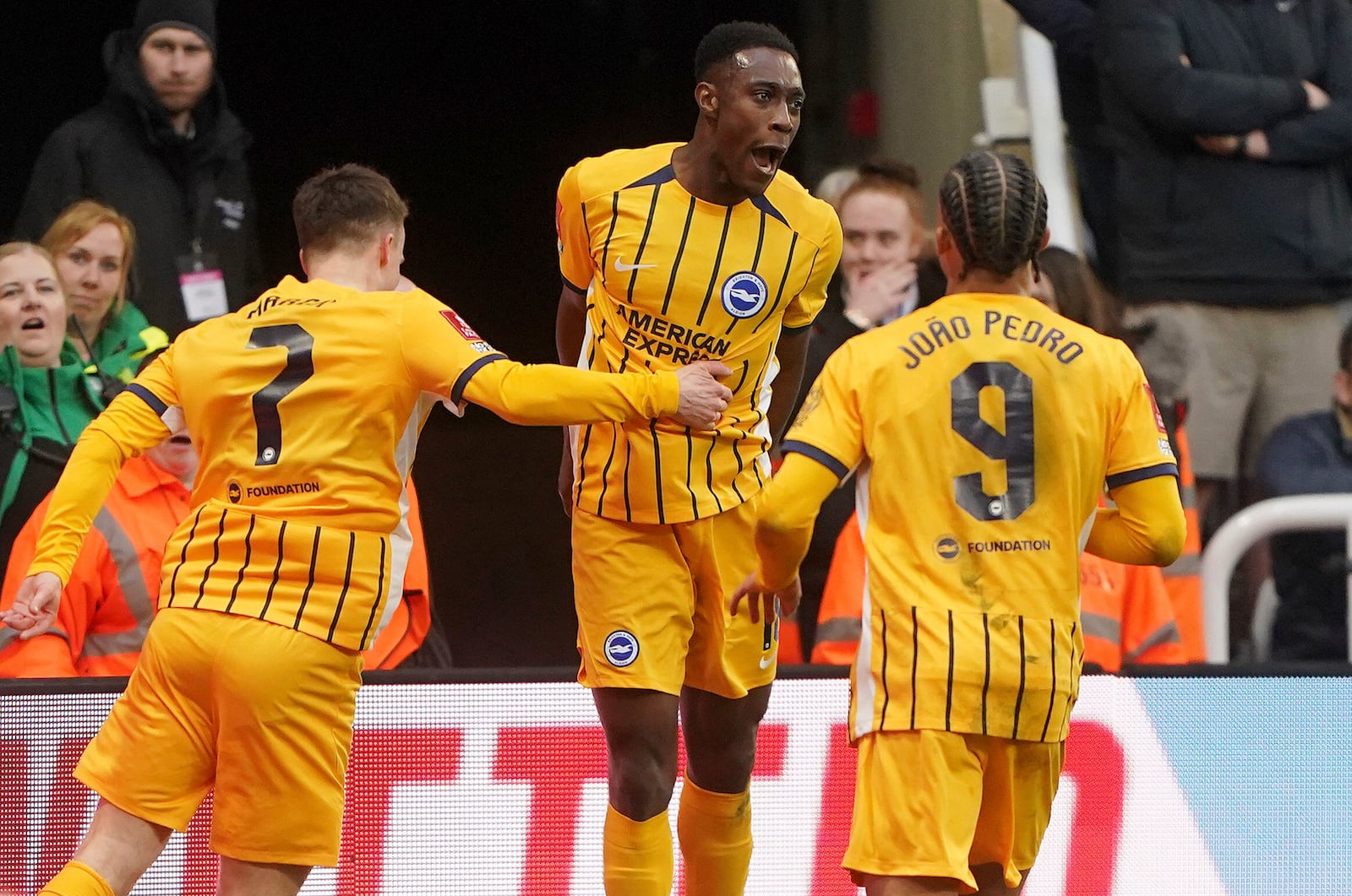 Brighton and Hove Albion's Danny Welbeck, centre, celebrates with teammates after scoring their side's second goal during the FA Cup fifth round match between Newcastle United and Brighton and Hove Albion at St James' Park, Newcastle, England, Sunday, March 2, 2025. (Owen Humphreys/PA via AP)