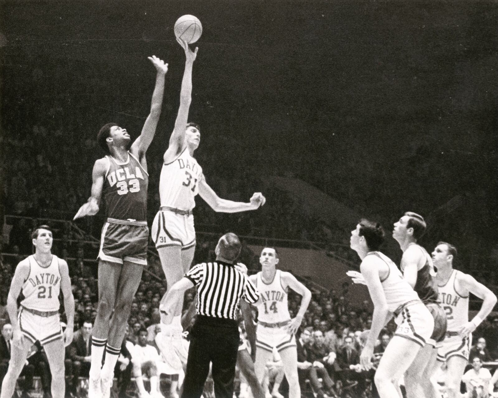 Dayton’s Dan Obrovac jumps for the opening tip against UCLA’s Lew Alcindor in the 1967 national championship game. FILE PHOTO