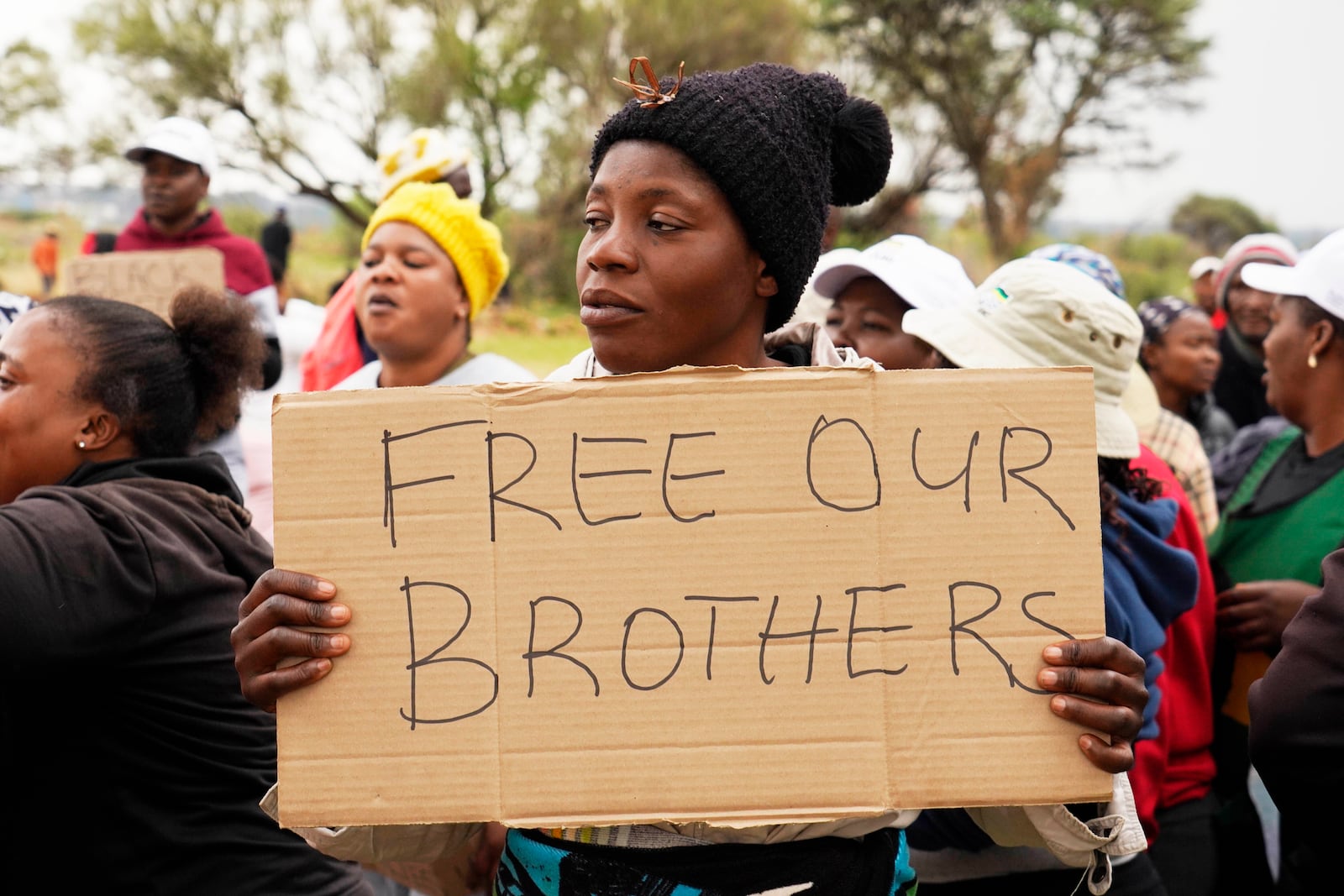 FILE - Relatives and friends protest near a reformed gold mineshaft where illegal miners are trapped in Stilfontein, South Africa, Friday, Nov. 15, 2024. (AP Photo/Denis Farrell, File)