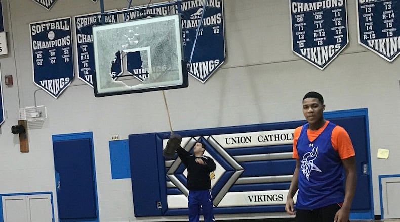 Jordan Pierce stands in front of the broken backboard at Union Catholic on Monday. Photo by Jim Reagan