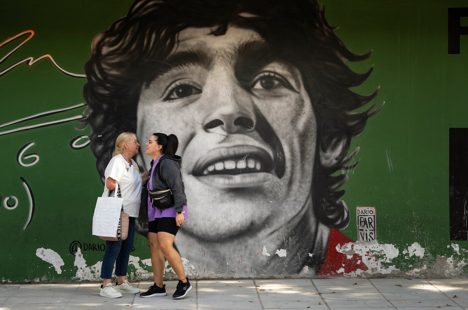 A mural of late soccer star Diego Maradona covers a wall in the La Paternal neighborhood of Buenos Aires, Argentina, Tuesday, March 11, 2025. (AP Photo/Rodrigo Abd)