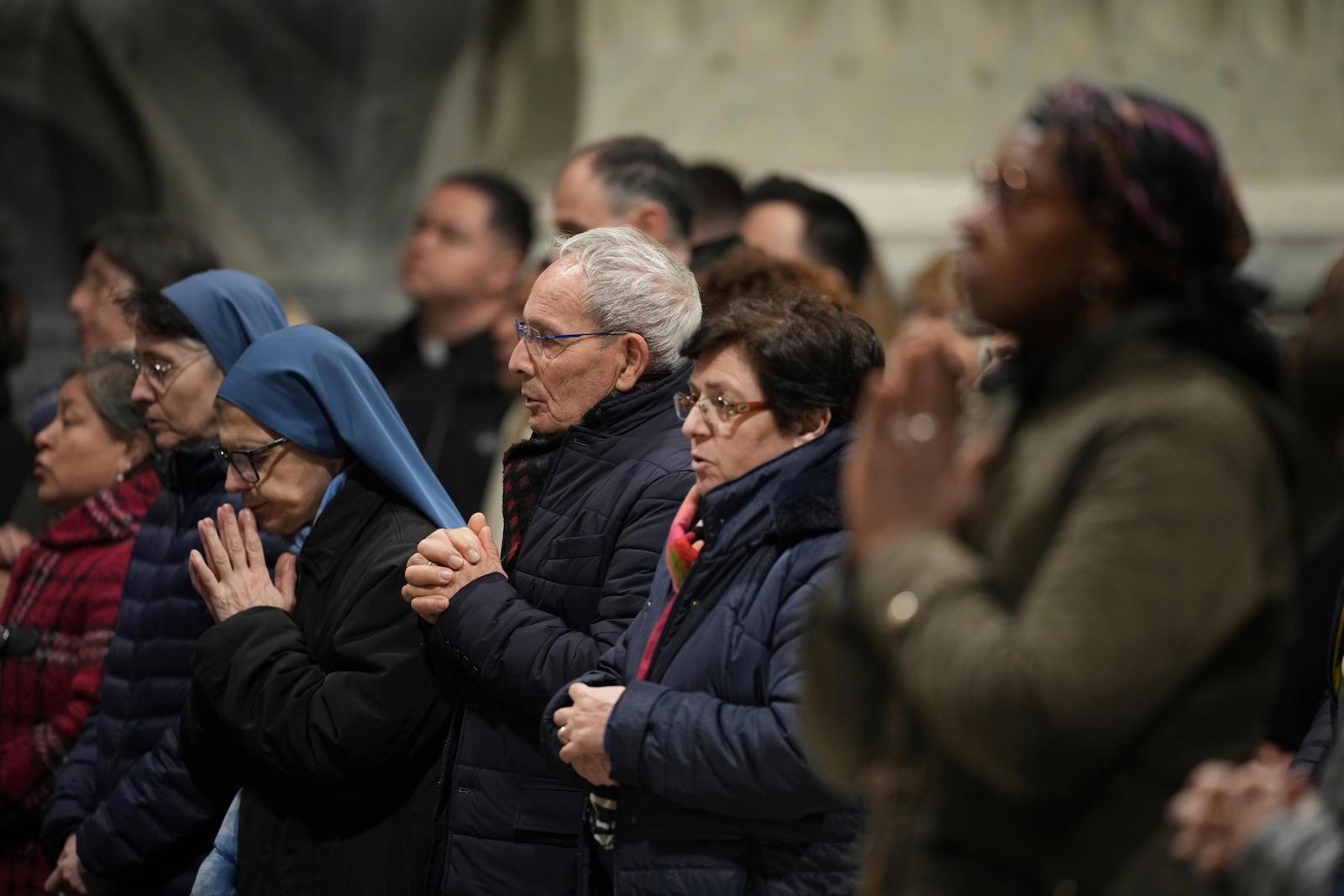 Faithful and nuns gather at St. John Lateran Basilica in Rome Sunday, Feb. 23, 2025, to pray for Pope Francis who was admitted over a week ago at Rome's Agostino Gemelli Polyclinic and is in critical condition. (AP Photo/Alessandra Tarantino)