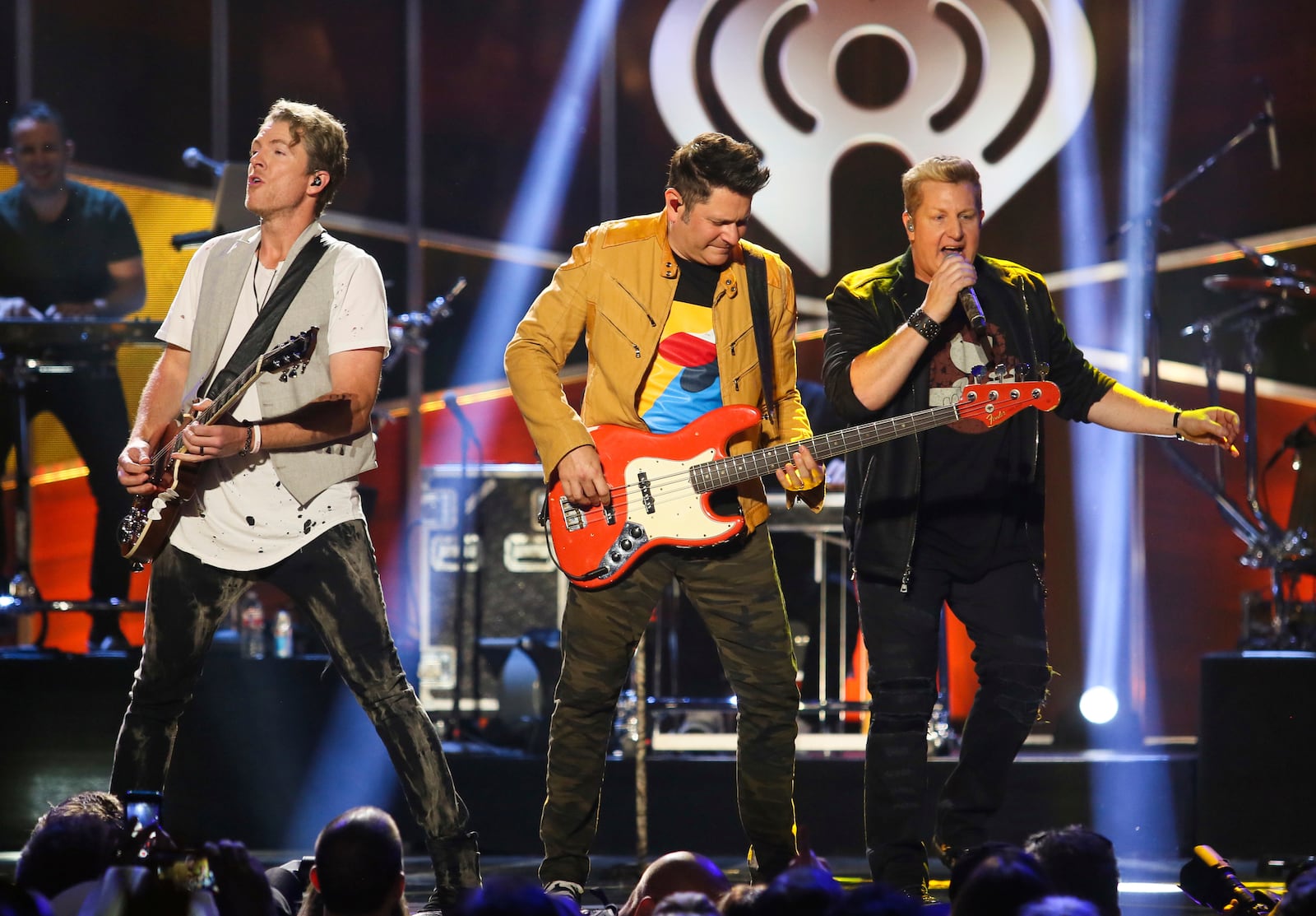 FILE - Rascal Flatts' Joe Don Rooney, from left, Jay DeMarcus and Gary LeVox perform at the iHeartCountry Festival in Austin, Texas. (Photo by Jack Plunkett]/Invision/AP, File)