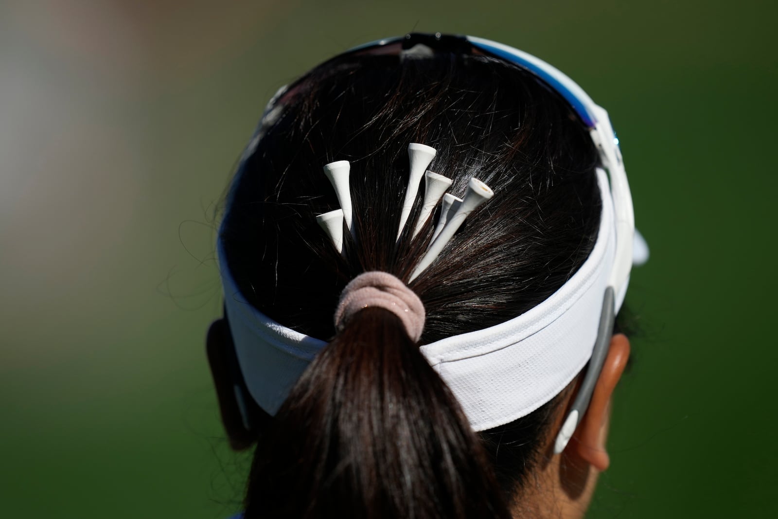 Chanettee Wannasaen of Thailand has tees in her hair on the 3rd green during the final round of the LPGA Ladies Championship golf tournament at the Seowon Valley Country Club in Paju, South Korea, Sunday, Oct. 20, 2024. (AP Photo/Lee Jin-man)