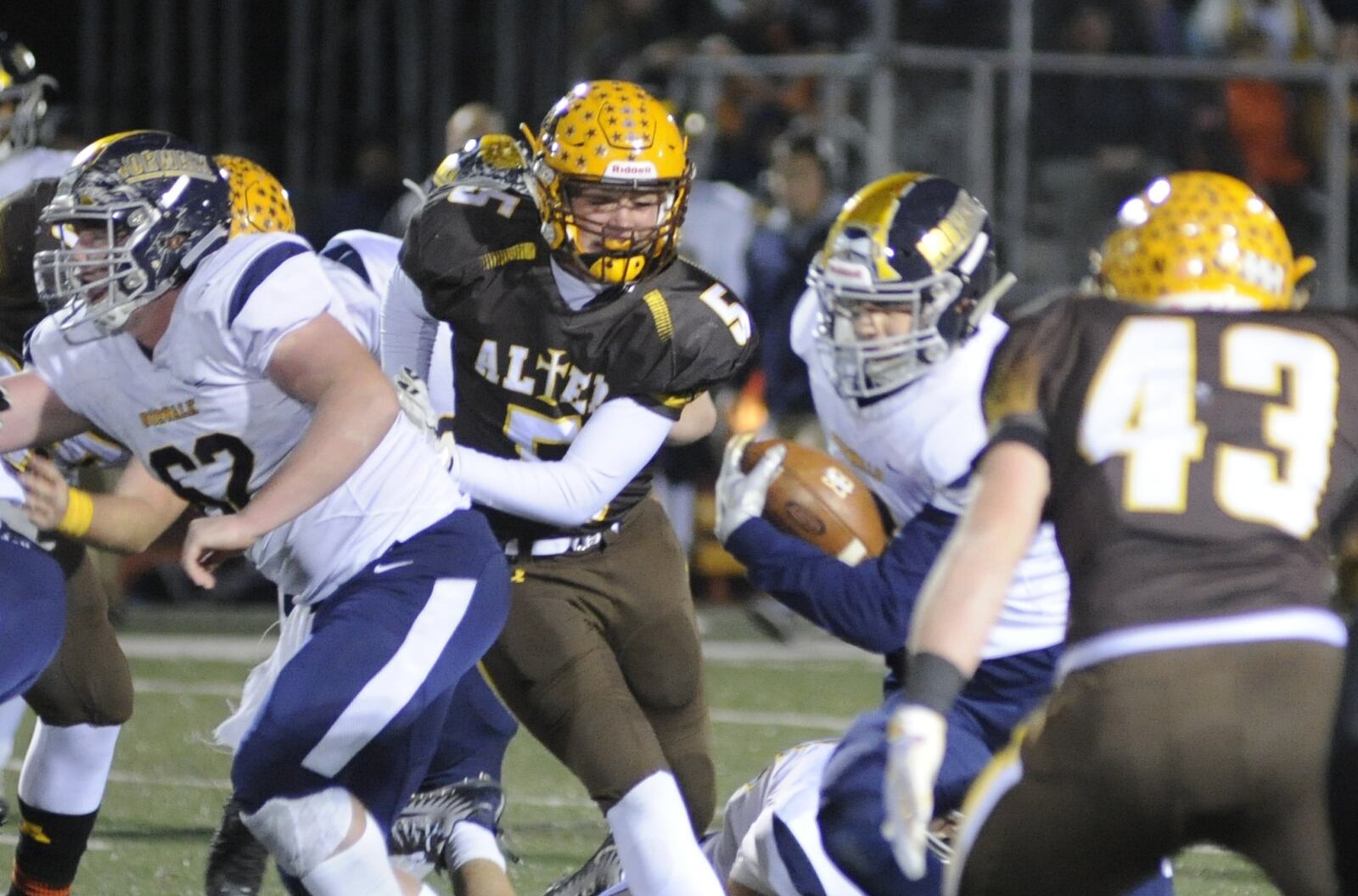 Alter’s Nolan Meyer (5) and Dan O’Connell (43) get defensive. Alter defeated Norwalk 34-13 in a D-III high school football state semifinal at Wapakoneta’s Harmon Field on Friday, Nov. 23, 2018. MARC PENDLETON / STAFF