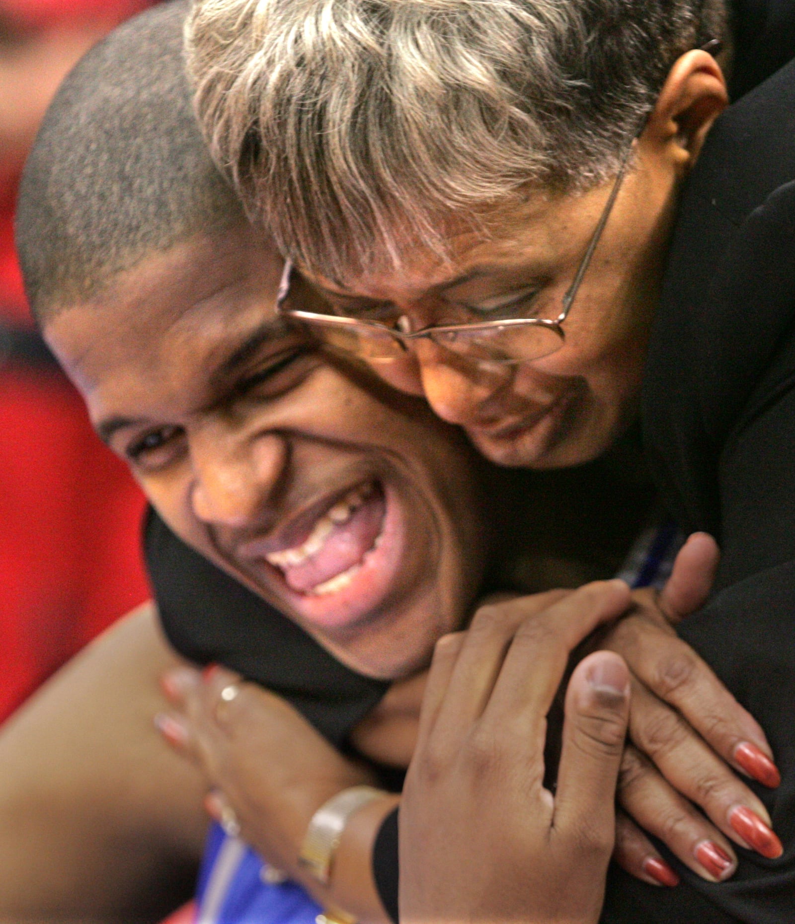 Mark Anderson is congratulated by Frances Winborn, the Dunbar athletic director, after they won the Division II basketball championship in March, 2006. DDN FILE PHOTO