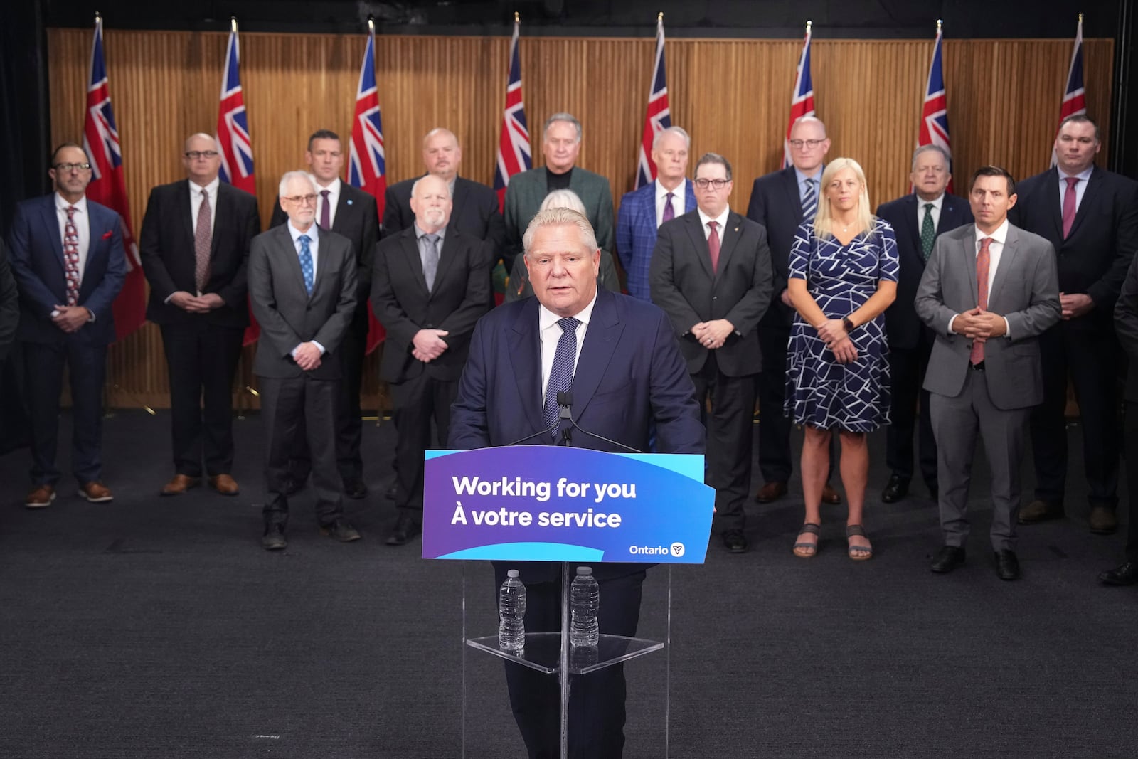 Ontario Premier Doug Ford speaks to members of the media as mayors from selected municipalities and government ministers look on the Queen's Park Legislature in Toronto on Thursday Dec. 12, 2024. (Chris Young/The Canadian Press via AP)