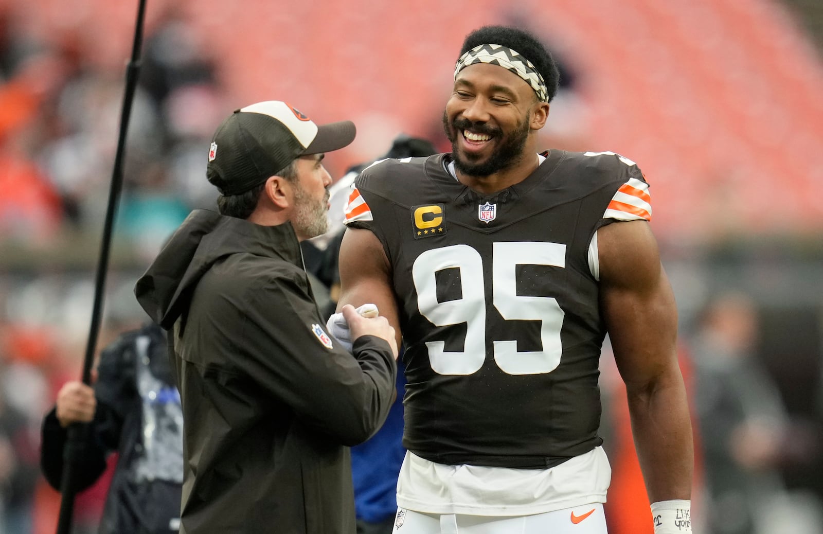 Cleveland Browns head coach Kevin Stefanski, left, talks with defensive end Myles Garrett (95) before an NFL football game against the Miami Dolphins Sunday, Dec. 29, 2024, in Cleveland. (AP Photo/Sue Ogrocki)