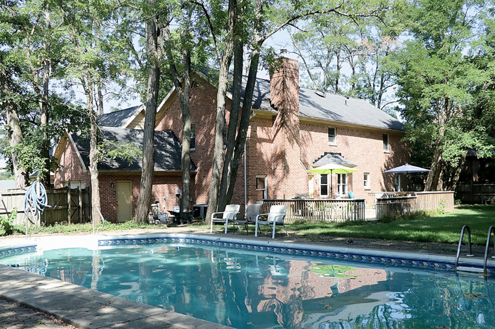 A single door off the family room opens to a two-level wooden deck and private back yard. A wooden privacy fence surrounds the tree covered yard that includes an in-ground swimming pool. CONTRIBUTED PHOTO BY KATHY TYLER