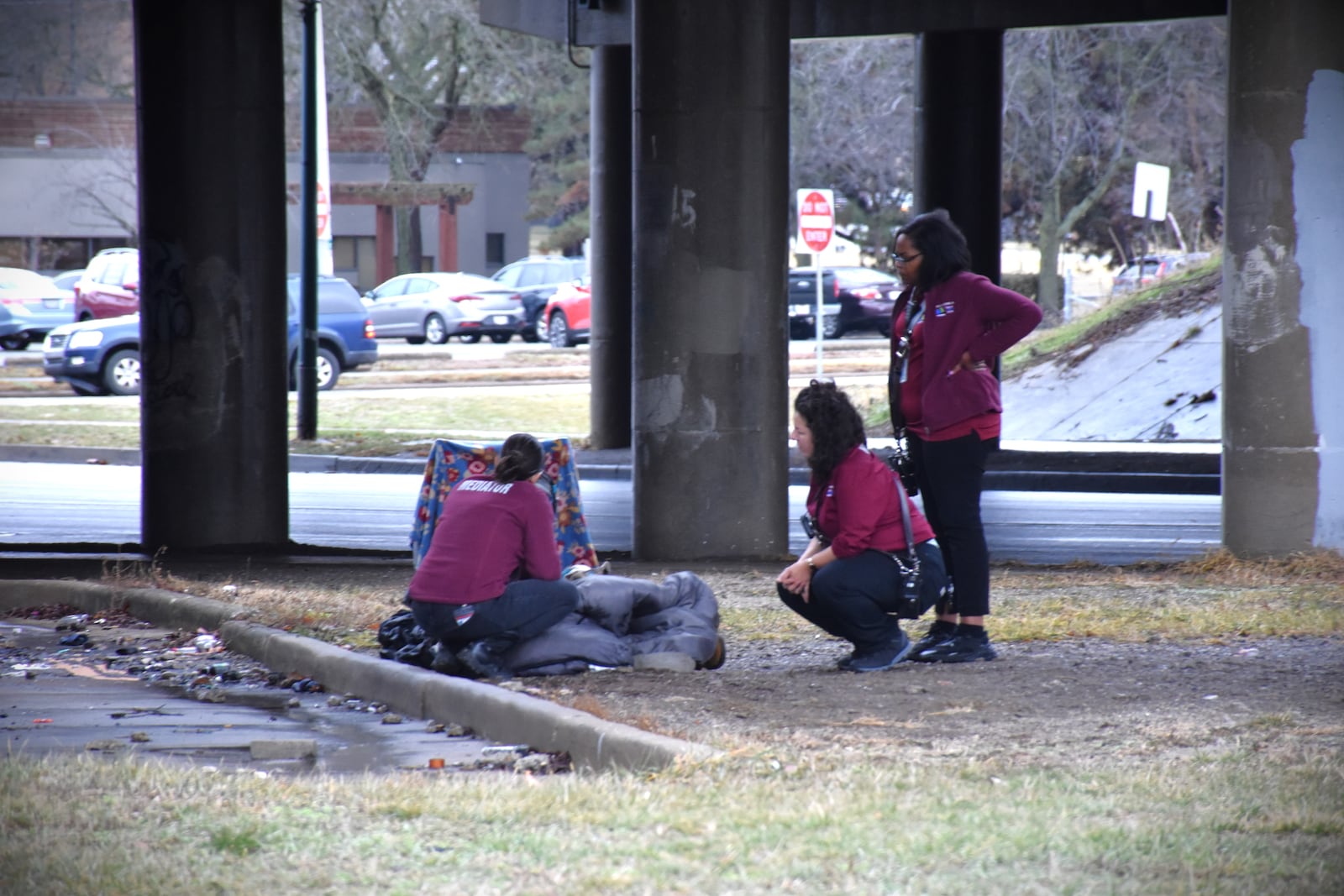 Mediation response specialists with Dayton's Mediation Response Unit interact with someone who was sleeping underneath the U.S. 35 overpass at Wayne Avenue. CORNELIUS FROLIK / STAFF