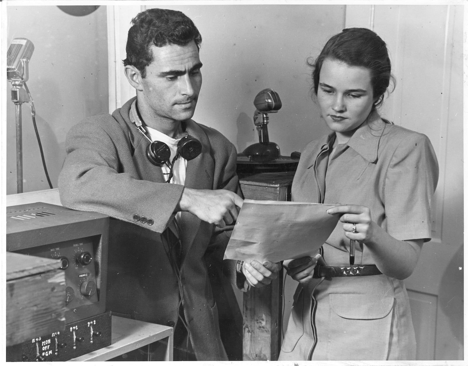 Rod Serling, student at Antioch College, at Yellow Springs, won a nation-wide radio script contest, writes an original radio play every week on the kitchen table of a campus trailer, while his wife and fellow student, Carol, hits the textbooks or keeps the household running. Each week, too, he casts his play, directs it, plans music and sound effects for it and produces it over a Springfield radio station. His wife looks over his script. (Photo source: Antiochiana archive at Antioch College. According to the Yellow Springs News, this photo appeared in the Cleveland Plain Dealer on May, 23 1949)