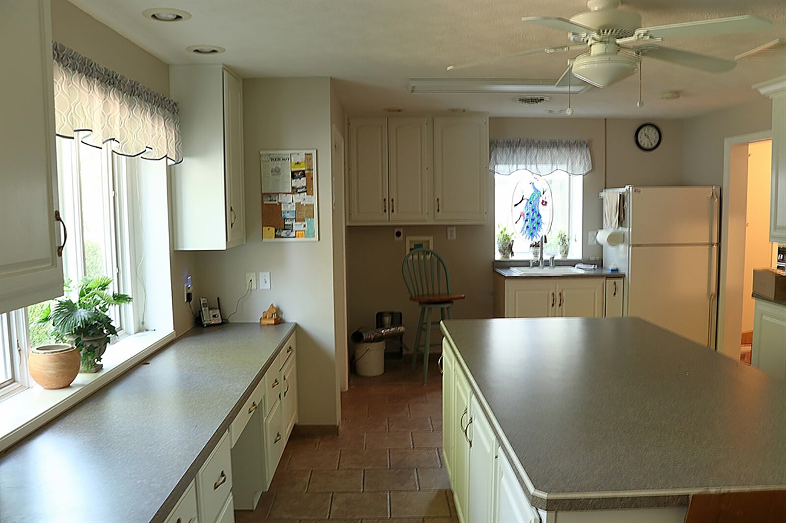 Toward the back, a multipurpose room offers storage, an island, closets, laundry hook-ups, a desk below a large window, access to the back yard and garage area. CONTRIBUTED PHOTO BY KATHY TYLER