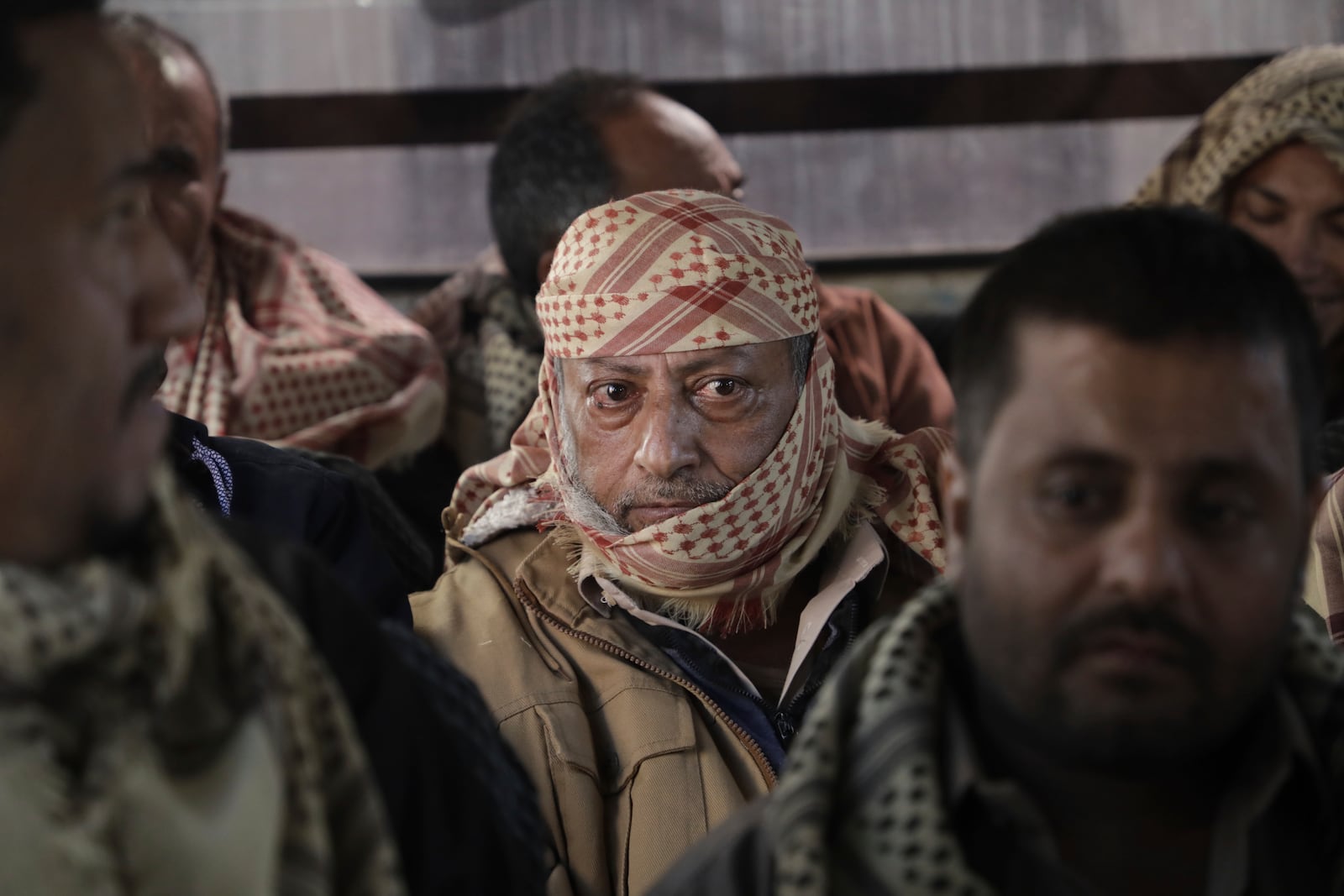 Released prisoners loyal to the Yemeni government wait for their relatives after their release, in Sanaa, Yemen, Saturday, Jan. 25, 2025. (AP Photo/Osamah Abdulrahman)