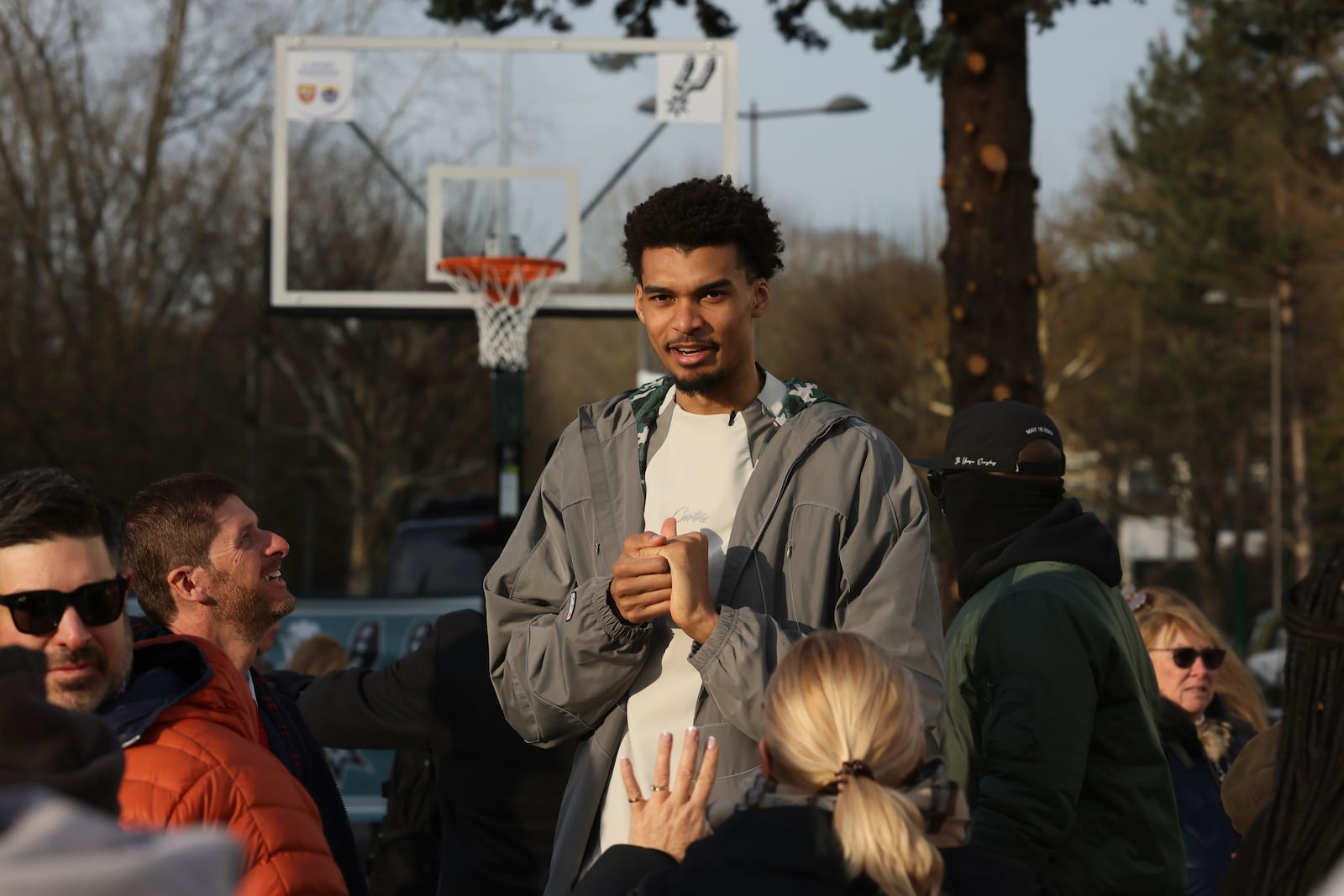 San Antonio Spurs' Victor Wembanyama meets residents as he inaugurates a basketball court, Tuesday, Jan. 21, 2025 in Le Chesnay-Rocquencourt, south of Paris. (AP Photo/Thomas Padilla)