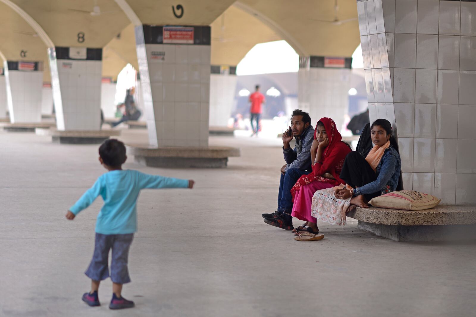 Stranded passengers wait at a railway station after trains across the country have been canceled as railway workers went on strike for higher pensions and other benefits, in Dhaka, Bangladesh, Tuesday, Jan. 28, 2025. (AP Photo/Mahmud Hossain Opu)