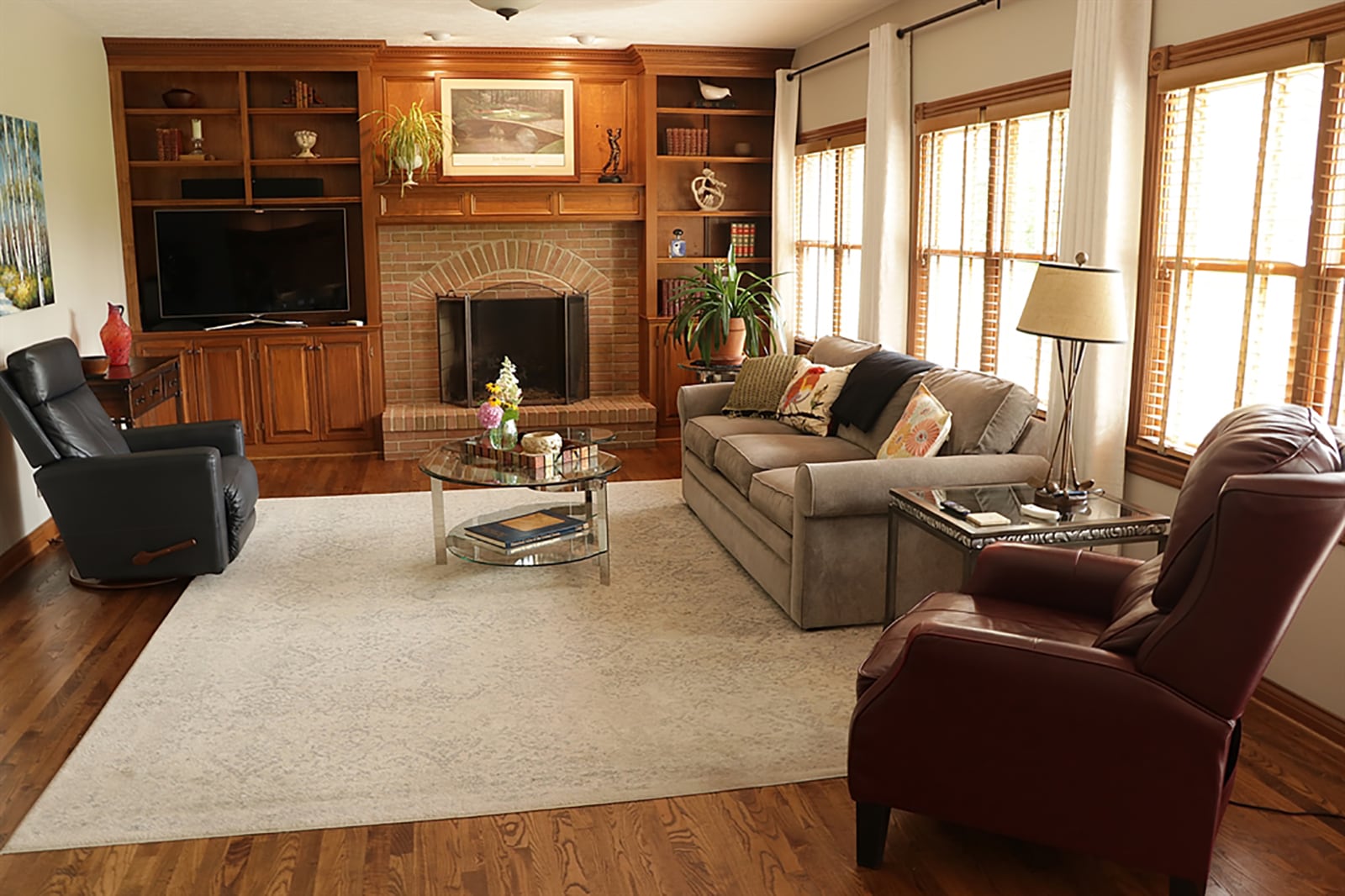 Detailed wood panels and wainscoting surround a wood-burning fireplace and create open bookcases and media shelves in the great room. There are a few cabinets and a wood mantel over the brick arched fireplace which has a raised hearth. CONTRIBUTED PHOTO BY KATHY TYLER