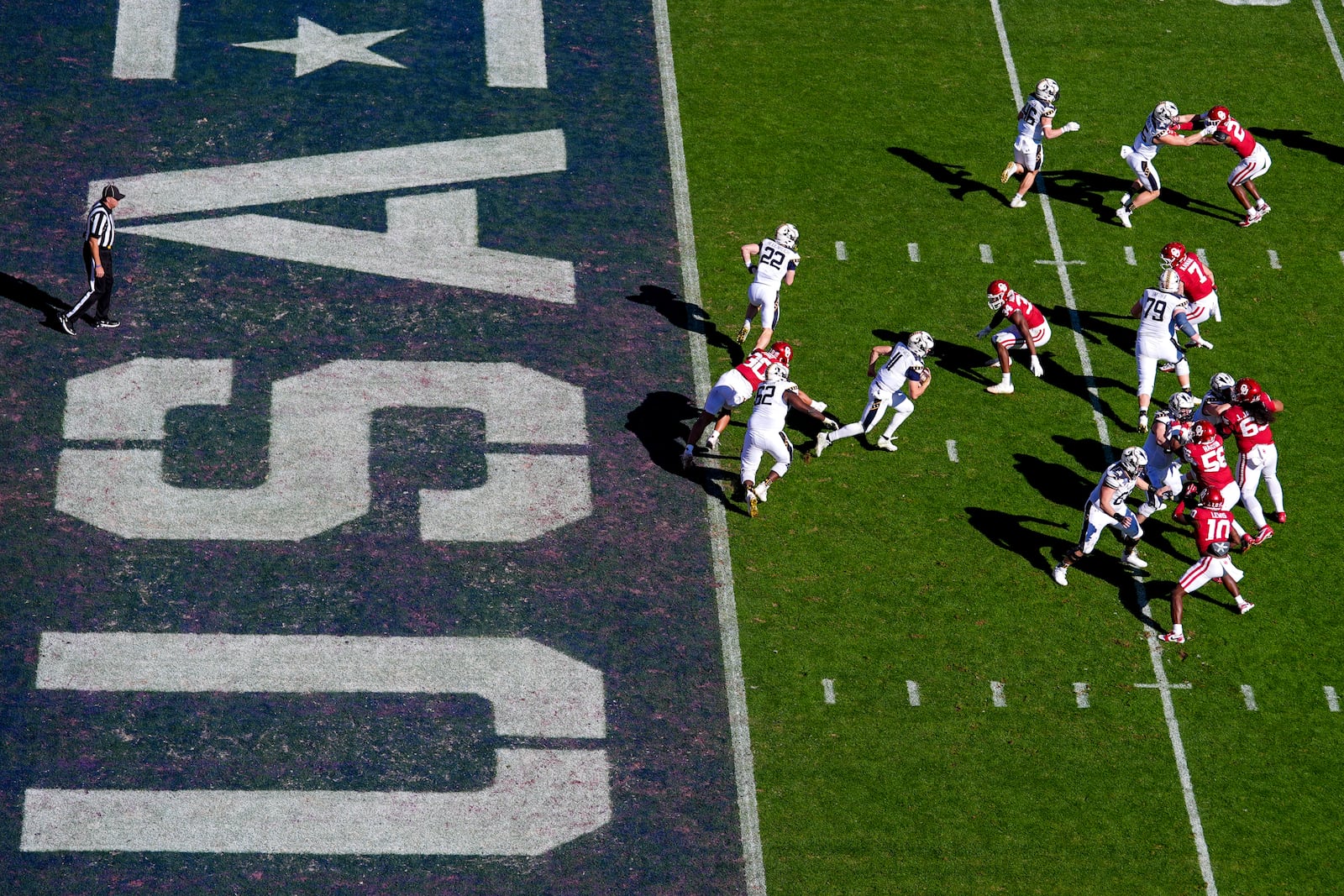 Navy quarterback Blake Horvath, center, runs with the ball on his way to a 95-yard touchdown run during the second half of the Armed Forces Bowl NCAA college football game against Oklahoma, Friday, Dec. 27, 2024, in Fort Worth, Texas. Navy won 21-20. (AP Photo/Julio Cortez)