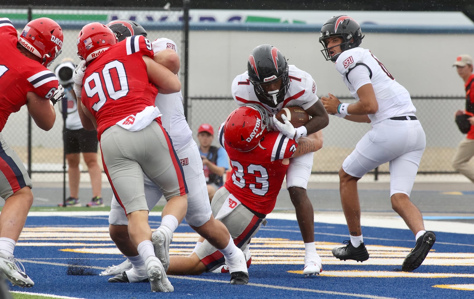 Dayton's Gideon Lampron (33) makes a tackle for a safety against St. Francis on Saturday, Aug. 31, 2024, at Welcome Stadium in Dayton. David Jablonski/Staff