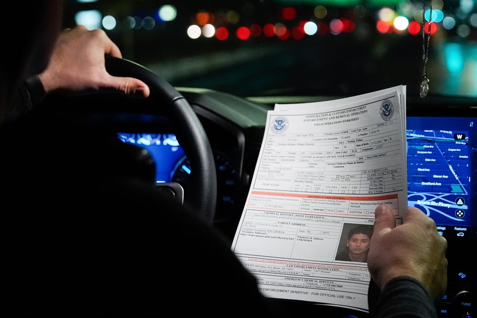 FILE - Kenneth Genalo, director of U.S. Immigration and Customs Enforcement's New York City field office, holds an information sheet on Wilmer Patricio Medina-Medina during an early morning operation, Dec. 17, 2024, in the Bronx borough of New York. (AP Photo/Julia Demaree Nikhinson, File)