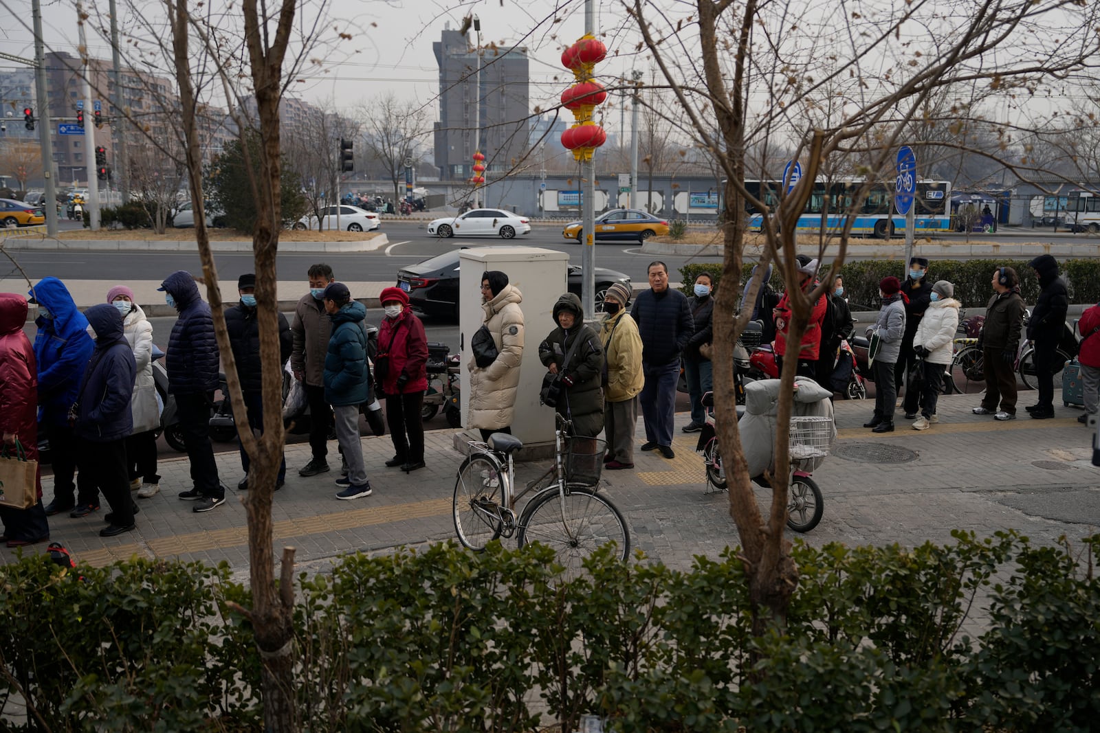 Residents line up to buy yuanxiao, a traditional Chinese food made with glutinous rice flour and sweet fillings consumed as part of the upcoming Lantern Festival celebrations, at the Jinfang Snacks Shop in Beijing, Tuesday, Feb. 11, 2025. (AP Photo/Ng Han Guan)