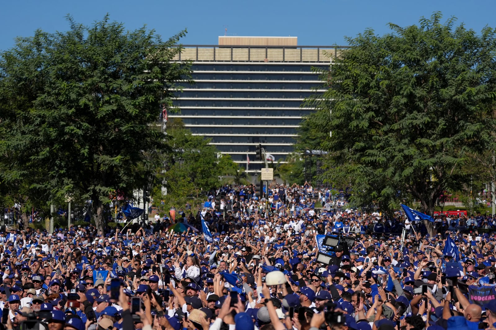 Fans cheer before the Los Angeles Dodgers baseball World Series championship parade Friday, Nov. 1, 2024, in Los Angeles. (AP Photo/Jae C. Hong)