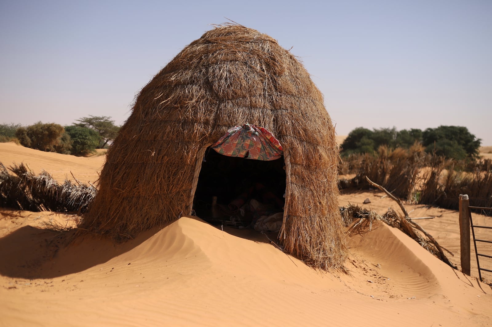 A hut is surrounded by sand in Chinguetti, Mauritania on Feb. 4, 2025. (AP Photo/Khaled Moulay)