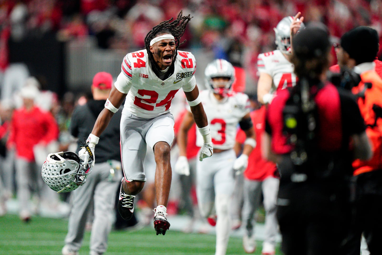 Ohio State cornerback Jermaine Mathews celebrates after the first half of the College Football Playoff national championship game against Notre Dame Monday, Jan. 20, 2025, in Atlanta. (AP Photo/Jacob Kupferman)