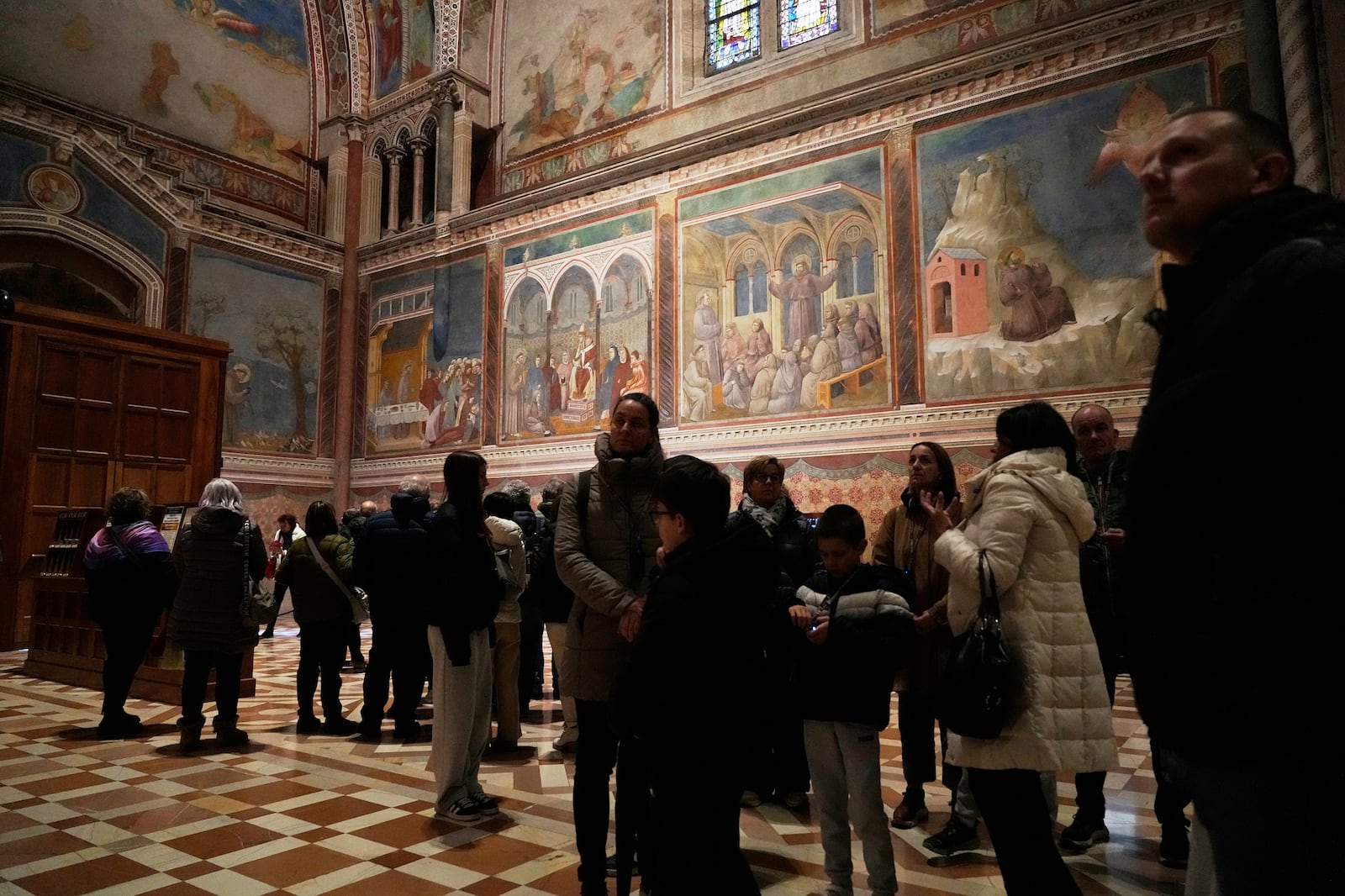 Visitors look at Giotto's frescoes inside St. Francis Basilica in Assisi, Italy, Saturday, March 1, 2025. (AP Photo/Gregorio Borgia)