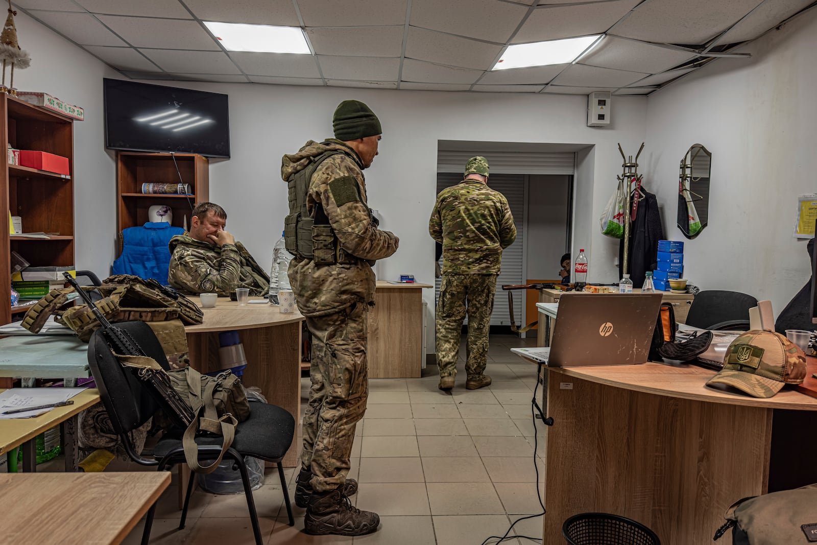 Artem Shchus, colonel of the Kurakhove police unit, left, sits in a basement in Kurakhove, Donetsk region, Ukraine, on Nov. 7, 2024. (AP Photo/Anton Shtuka)