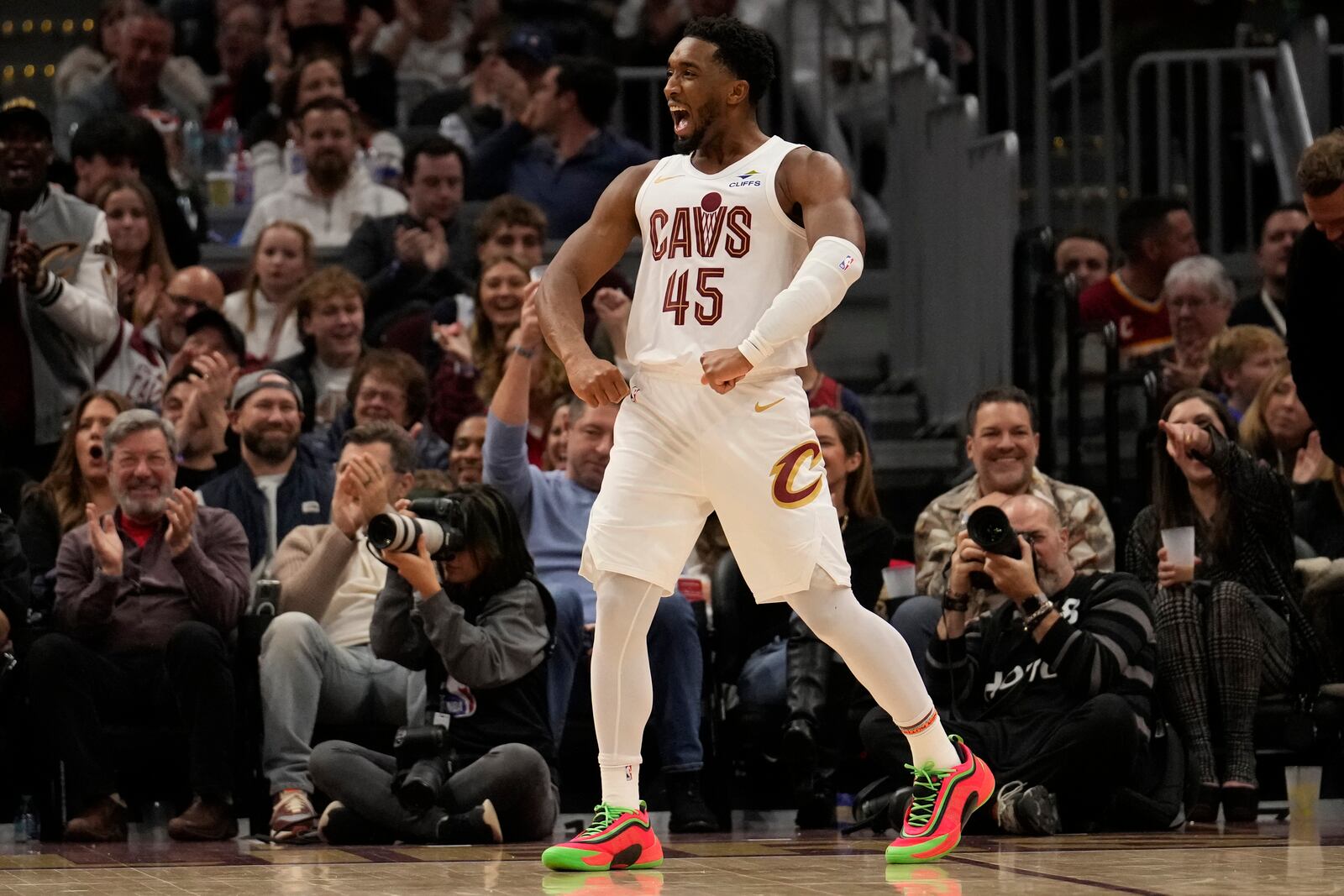 Cleveland Cavaliers guard Donovan Mitchell (45) celebrates in the second half of an NBA basketball game against the Milwaukee Bucks, Friday, Dec. 20, 2024, in Cleveland. (AP Photo/Sue Ogrocki)