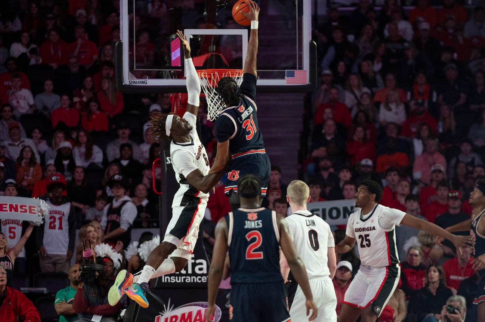 Georgia center Somto Cyril (6) reaches to block the shot of Auburn forward Chaney Johnson (31) during the first half of an NCAA college basketball game, Saturday, Jan. 18, 2025, in Athens, Ga. (AP Photo/Kathryn Skeean)