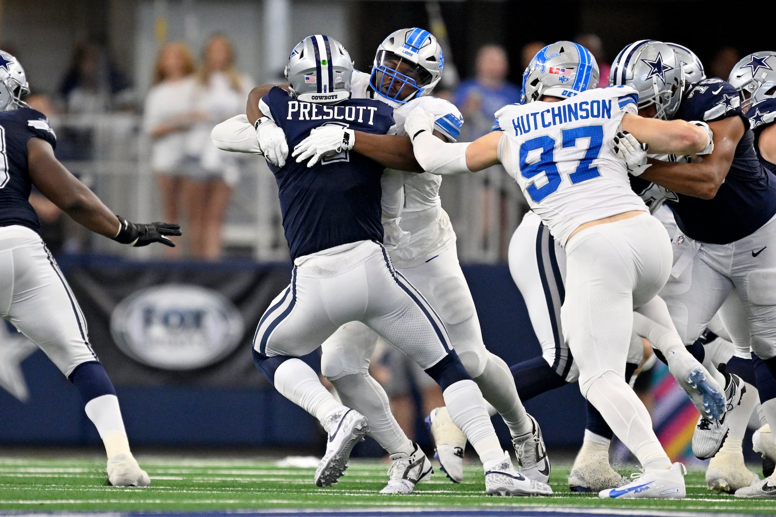 Dallas Cowboys quarterback Dak Prescott (4) is sacked by Detroit Lions defensive tackle Alim McNeill, rear, with pressure from Aidan Hutchinson (97) in the first half of an NFL football game in Arlington, Texas, Sunday, Oct. 13, 2024. (AP Photo/Jerome Miron)