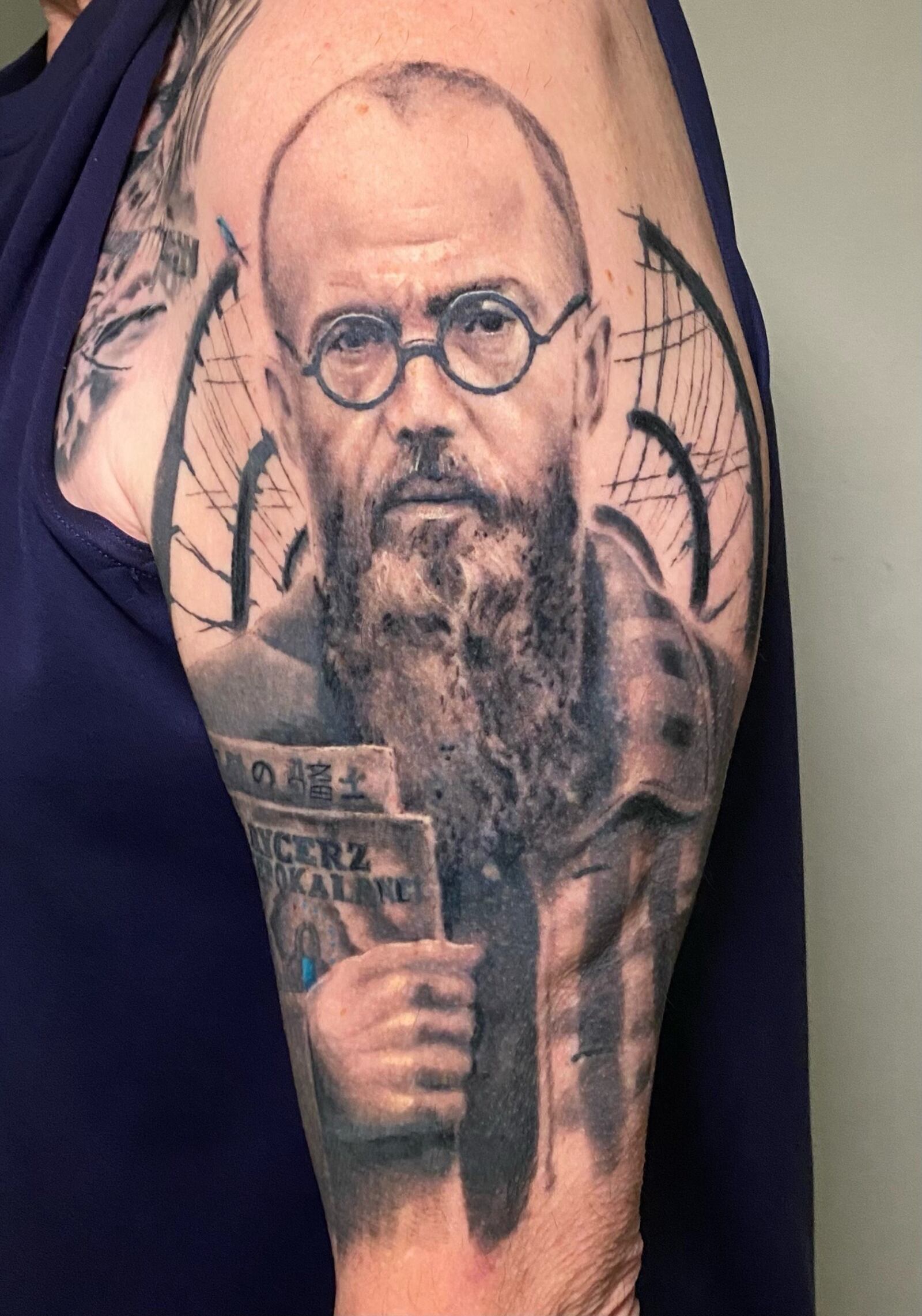 On his shoulder, Mark Haufe has the haunting portrait of St, Maximilian Kolbe, The Martyr of Auschwitz. At the infamous Nazi extermination camp, the Polish Catholic priest volunteered to take on the death sentence of a Polish army sergeant who had a family. He was canonized by Pope John Paul II in 1982. Also known as The Martyr of Charity, he is the patron saint of political prisoners and journalists. Aisle 9 artist Evan Chandler did the portrait of Kolbe. CONTRIBUTED