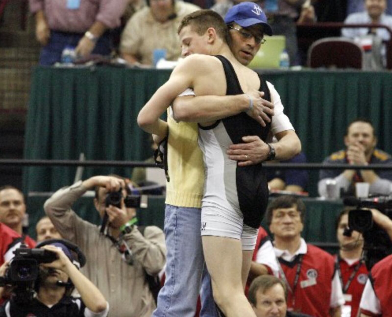 David Taylor of Graham gets a hug from coach Jeff Jordan after defeating Manuel Cintron of Alliance at 135 lbs. to become a four-time Ohio state wrestling champion Saturday, March 7, 2009, at the Schottenstein Center in Columbus.
Staff Photo by Barbara J. Perenic