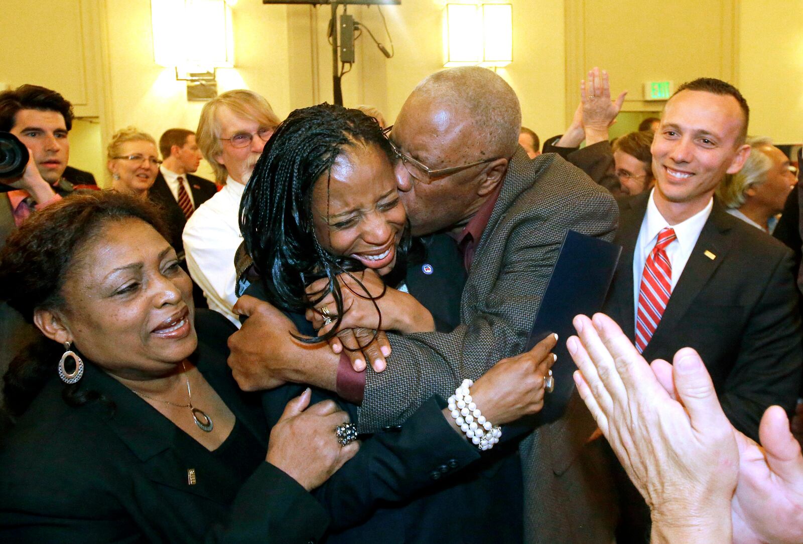 FILE - Republican Mia Love celebrates with her father, Jean Maxime Bourdeau, after winning the race for Utah's 4th Congressional District during election night in Salt Lake City, Nov. 4, 2014. (AP Photo/Rick Bowmer, File)