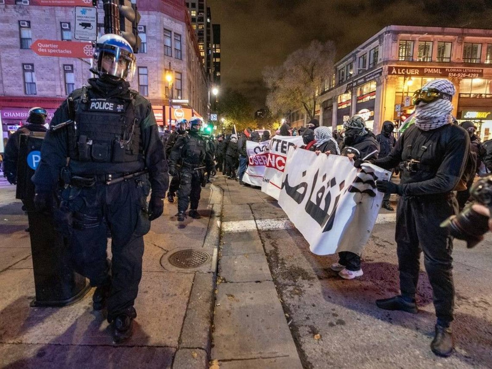 Riot police line the sidewalk on St-Laurent Blvd. in Montreal during protests against the NATO Parliamentary Assembly in November 2024.